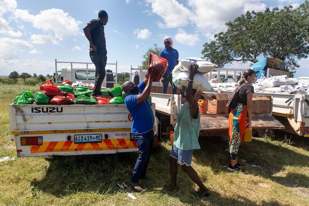 Three supply trucks distributing aid