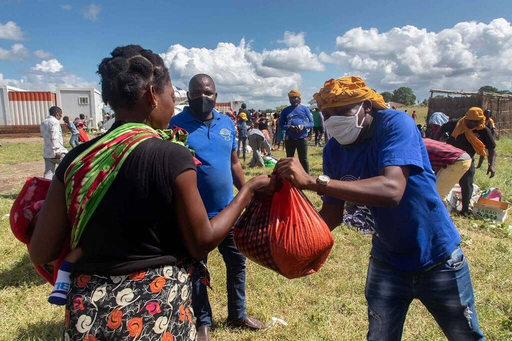 Woman recieving bag of supplies